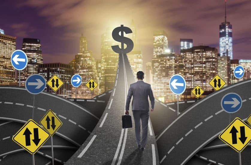 A man carrying an attaché bag walking along a busy street toward a dollar sign at the end of the road.