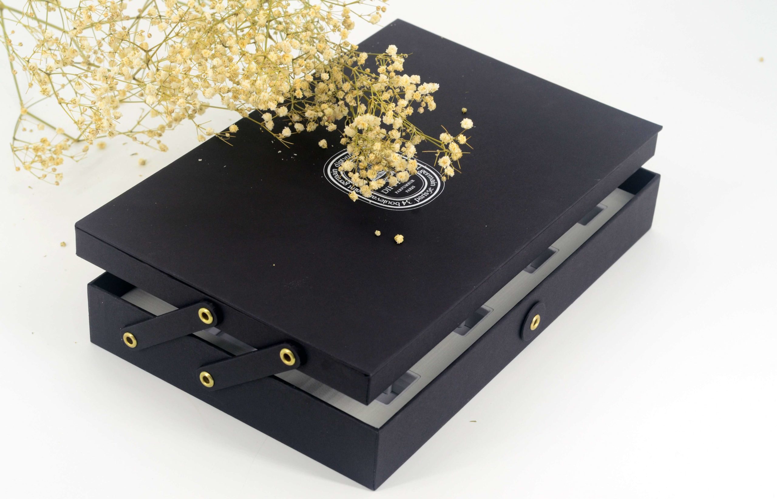 black decorative box with petals behind it