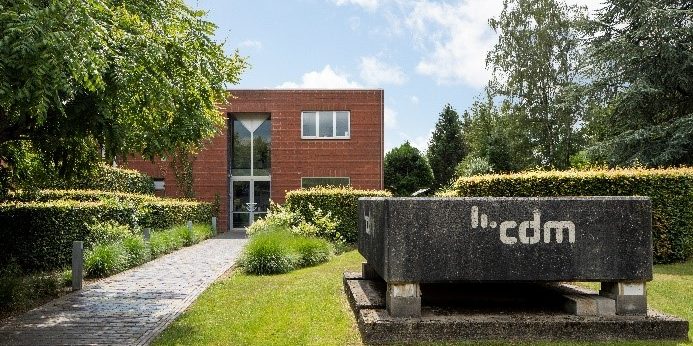 CDM office building surrounded by trees and bushes