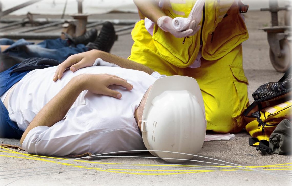 someone laying on the floor receiving treatment from paramedic