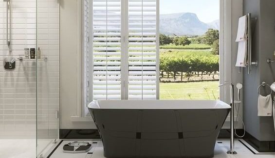 bathroom, including bathtub and shower, with open doors in the background