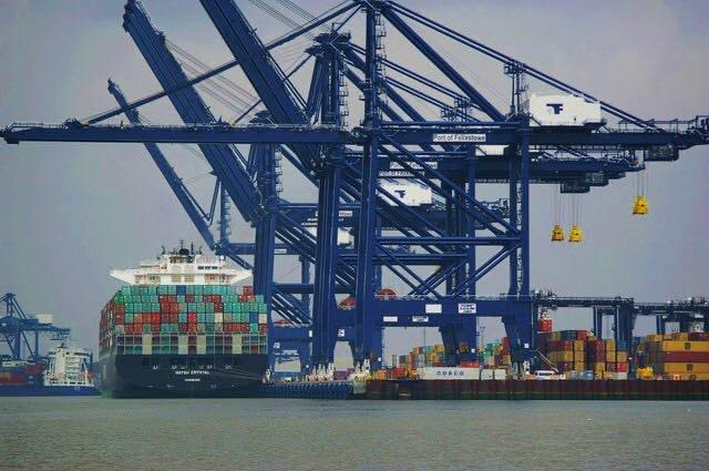 a massive blue crane on a shipyard