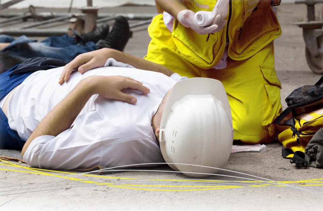 someone laying on the floor receiving treatment from paramedic