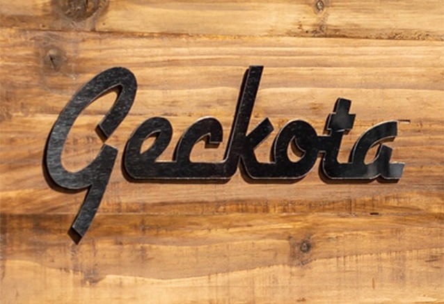 Geckota logo placed on a wooden background.
