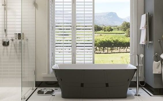 bathroom, including bathtub and shower, with open doors in the background