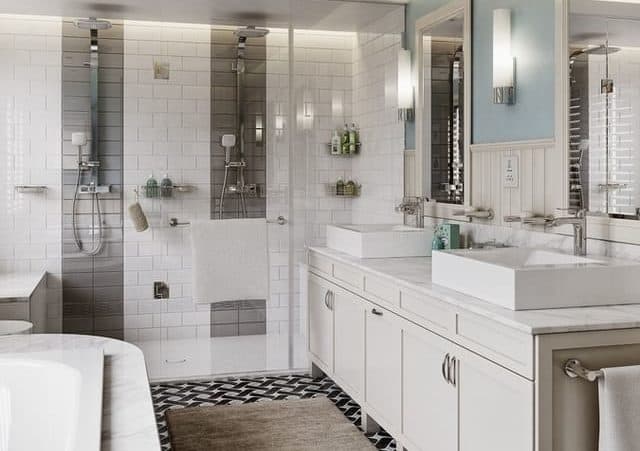 Open plan bathroom, including a bath and a shower, with sink, all white