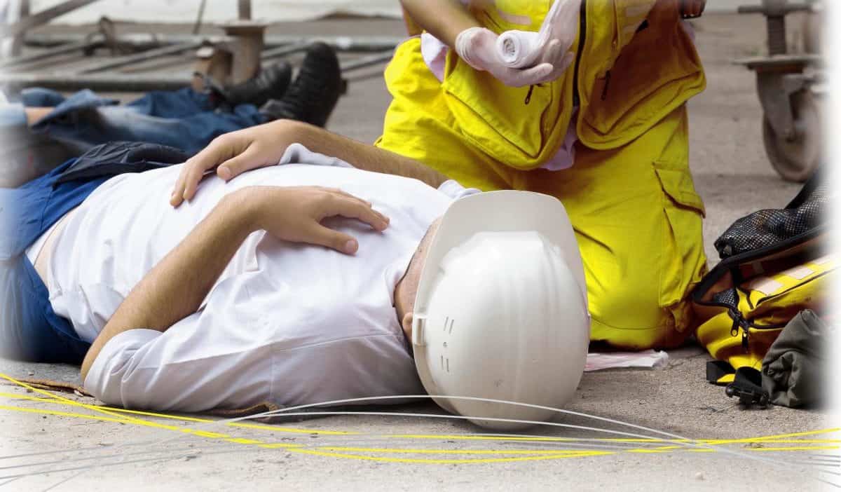 someone laying on the floor receiving treatment from paramedic