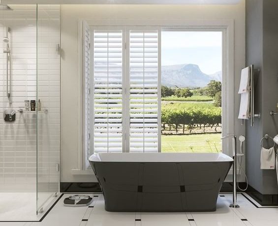 bathroom, including bathtub and shower, with open doors in the background