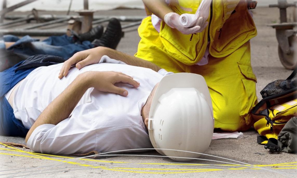 someone laying on the floor receiving treatment from paramedic