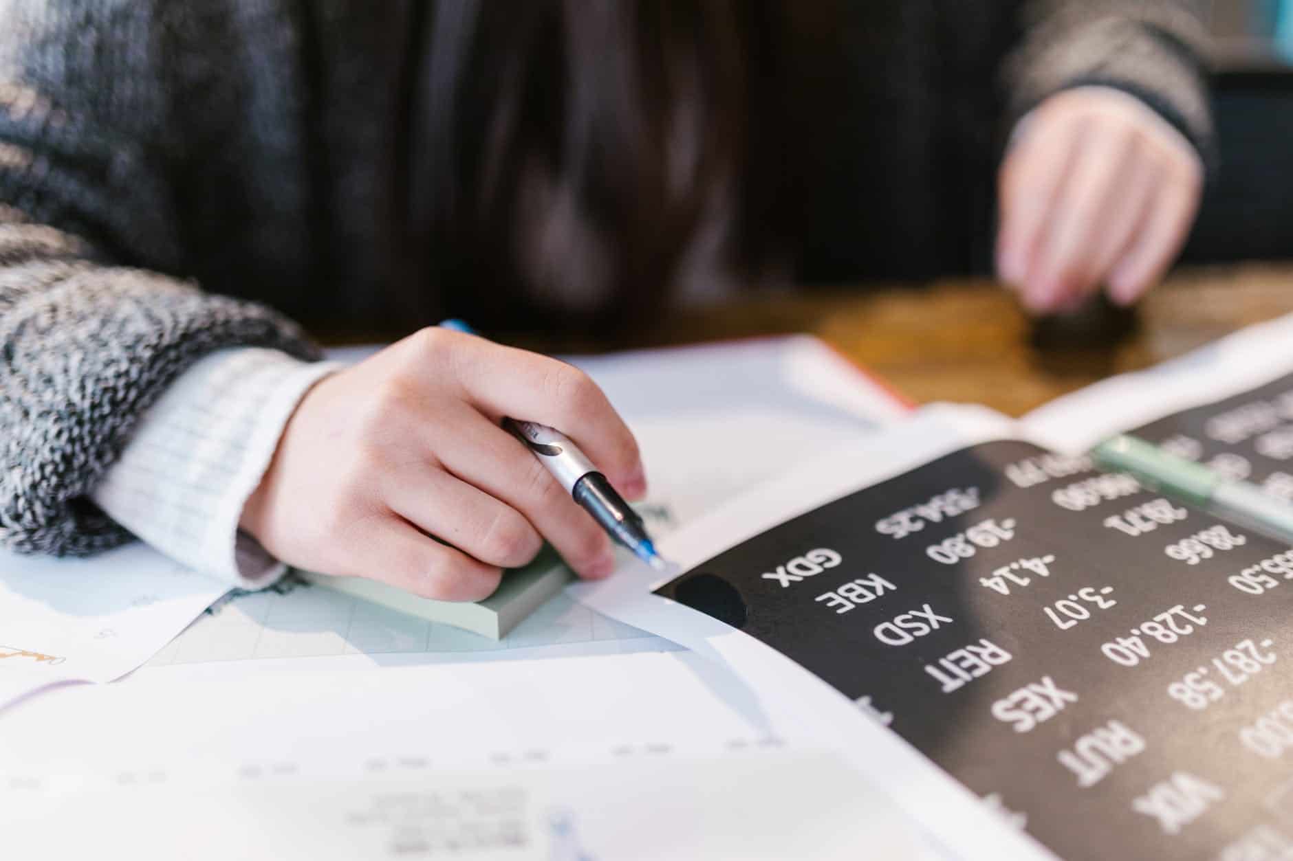 person writing on white paper