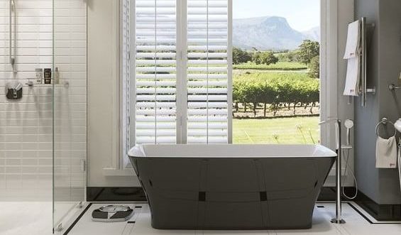 bathroom, including bathtub and shower, with open doors in the background