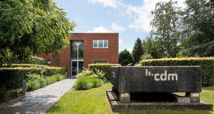 CDM office building surrounded by trees and bushes