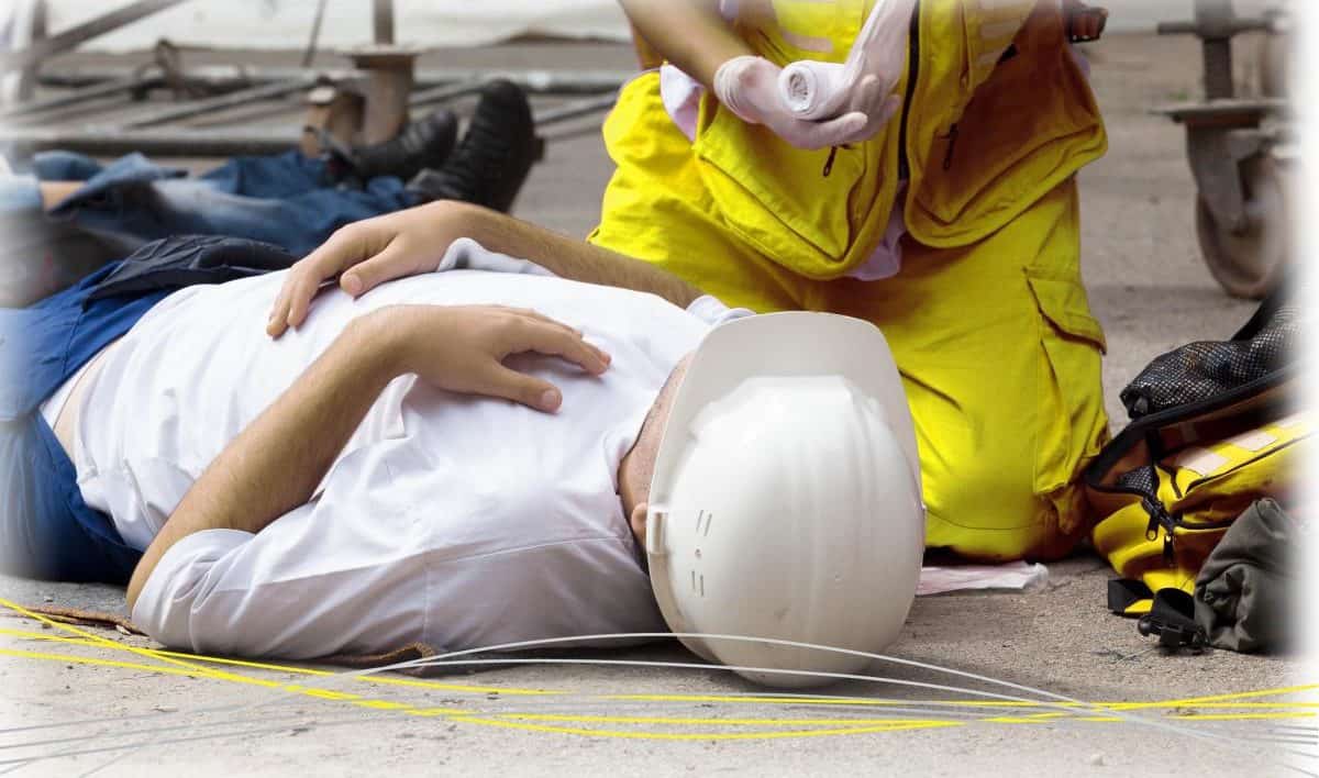 someone laying on the floor receiving treatment from paramedic