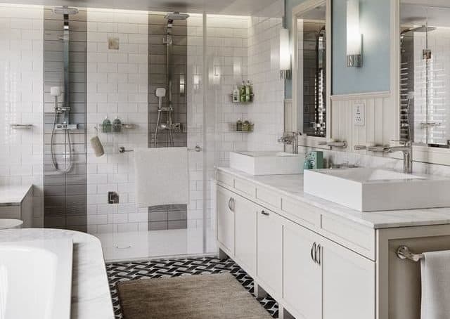 A modern and stylish all white bathroom that includes a double shower with two basins, two mirrors and a bath.