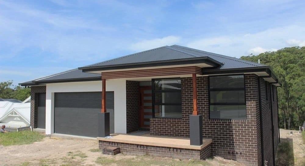 A newly built modern suburban house in the daytime.