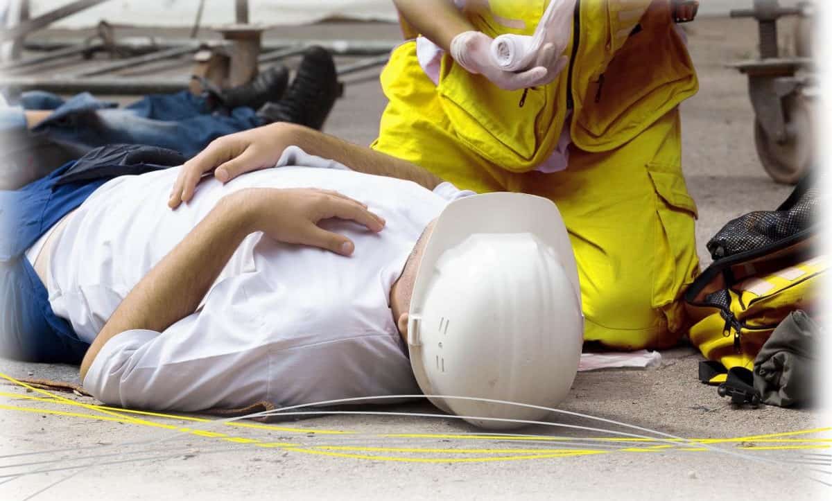 someone laying on the floor receiving treatment from paramedic