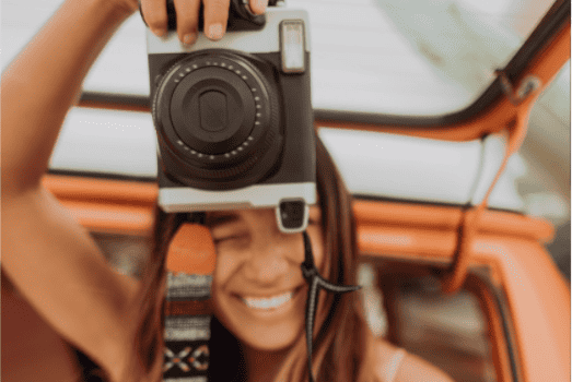 close up of a lady taking a photo with a professional camera in her hands