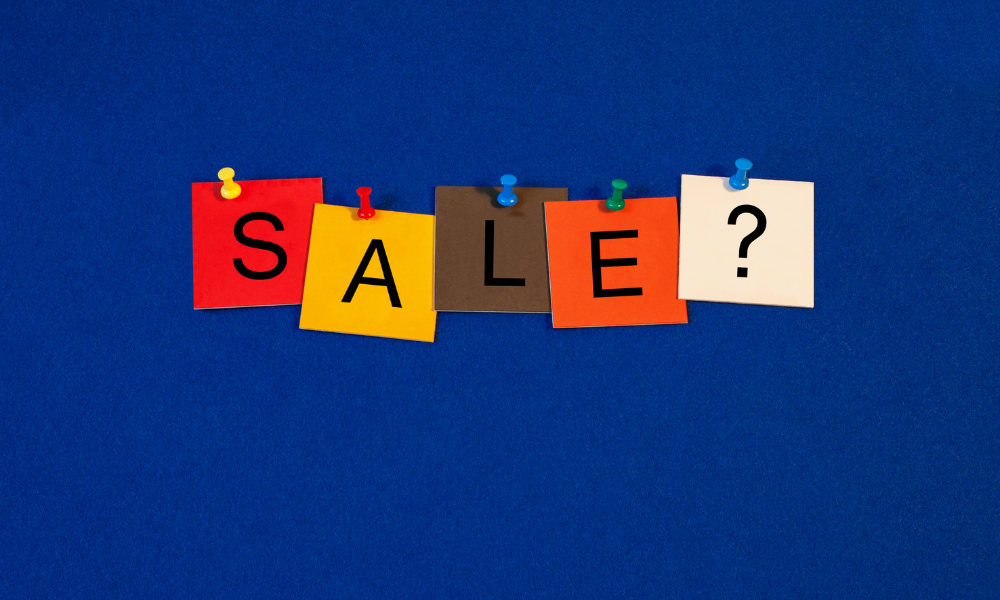 Image of pinned up letters that says sale question mark